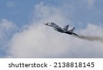 Small photo of Zeltweg Austria SEPTEMBER, 3, 2016 Military fighter jet aircraft rise in blue sky with clouds and black smoke. Mikoyan MiG29 Fulcrum of Polish Air Force. Copy space for News Title