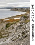 Small photo of Rocky shores of the Porsanger Fjord, Barents Sea, on a calm late summer evening, Finnmark, Norway