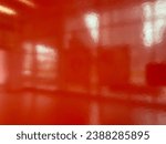 photo of orange glossy wall with a blurry reflective shiny effect that give a creative atmosphere