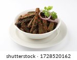 Small photo of Bhindi kurkure or crunchy okra or ladies' fingers, a Rajasthani traditional dish served in a white ceramic bowl along with raw bhindi aside
