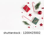 Christmas composition. Gifts, fir tree branches, red decorations on white background. Christmas, winter, new year concept. Flat lay, top view, copy space
