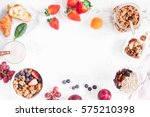 Healthy breakfast with muesli, fruits, berries, nuts on white background. Flat lay, top view, copy space.
