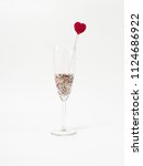 Small photo of Red heart swizzle stick in glass for decorate cocktail party