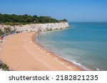 Stone Bay featuring sandy beach and chalk cliff in the seaside town of Broadstairs, east Kent, England
