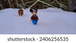 Small photo of Sumy, Ukraine - December 23, 2023 Witness the playful encounter of Lego Mickey Mouse and a prowling puma in a snowy landscape, a whimsical fusion of fantasy and nature