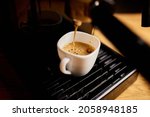 Small photo of Detail of a professional coffe maker dripping coffe into an empty cup in a cafeteria, Machine is making a perfect coffee with delicious smell, . Espresso Coffee Machine Making Espresso Coffee