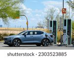 Small photo of Chandler, Arizona - May 15 2023: A Polestar 2 Electric vehicle parking at Electrify America EV charging stations offered to customers at the Phoenix Premium Outlets shopping center.