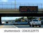 Small photo of Chandler, Gilbert, Arizona - July 25 2023: High pollution carpool advisery sign - Commuters in afternoon rush hour traffic along the loop 202 freeway in the East Valley area of metro Phoenix.