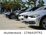 Small photo of FORT LAUDERDALE, FLORIDA/USA - MAY 31 2020 - Different color BMWs line up the parking lot in the afternoon sun at the dealership on 2601 S. Andrews Avenue