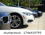 Small photo of FORT LAUDERDALE, FLORIDA/USA - MAY 31 2020 - Different color BMWs line up the parking lot in the afternoon sun at the dealership on 2601 S. Andrews Avenue