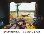 person view couple resting at camping woman laying in hammock with beautiful view of forest lake