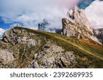Small photo of A man on the top enjoying Furchetta and Sass Rigais peaks in Seceda, Dolomites Alps, Odle mountain range, South Tyrol, Italy, Europe. Travel vacation concept.