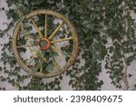 An old wooden wagon wheel has...