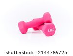 colored dumbbells isolated on white background. Pink dumbbells on a white background. Pink matte dumbbells isolated on white background.