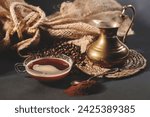 Small photo of A steaming coffee mug, golden coffee pot, and scattered beans: A warm tableau, the essence of a comforting coffee ritual.