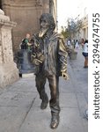 Small photo of Havana, Cuba May 2 2016: Statue of famous vagabond from Paris Jose Maria Lopez Lledin that wandered the streets of Havana, Cuba in Havana, Cuba with unidentified people in background