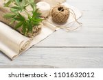 Hemp canvas and threads on a white wooden surface
