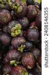 Small photo of Mangosteen (Garcinia mangostana) or Manggis in bahasa. mangosteen fruit taste is sweet and tangy, juicy, somewhat fibrous, with fluid-filled vesicle, deep reddish-purple colored rind.