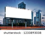 Billboard clear mock up in night streets of city useful for design