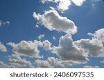 Small photo of clear blue sky with lots of white clouds. The sky seemed very vast and limitless. The clouds looked light and seemed as if they would float in the air