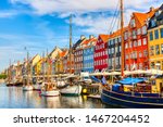 Copenhagen iconic view. Famous old Nyhavn port in the center of Copenhagen, Denmark during summer sunny day.