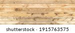 Small photo of Old wooden boards with cracks and a visible structure as well as gulp and knots. Alder board as a background for various natural designs and compositions. panoramic frame.
