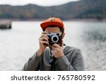 space for text, logo attractive hipster guy holding photo camera. handsome traveler shooting outdoor. mock up, young man taking pictures in the nature