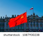 Soviet Union flag with the Russian flag and the Hermitage Museum in the background. In St. Petersburg, Russia 
