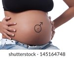 Small photo of The tummy of a woman far gone with child, having the Mars sign playfully drown around the navel.