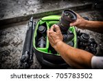 Photographe pack his camera and lenses to bagpack. Bag appliances for photography top view.High Dynamic Range tone