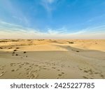 Small photo of Desert blue sky with sand yellow undertone Dubai daylight
