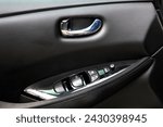 Small photo of Electric Car door trim with windows control. Car Inside Door Handle Interior. Door trim. Front door trim of a Electric car. Electric Car interior.