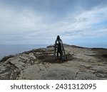 Small photo of Tintagel, Cornwall, UK - April 10 2018 The King Arthur statue Gallos by Rubin Eynon stands on a rocky headland on the Atlantic coast of Cornwall.