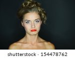Small photo of Portrait of a woman with look of verjuice on a dark background
