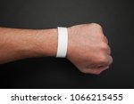 Empty event ticket wrist band design. Concert blank paper wristband, bracelet mockup on black background.