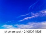 Small photo of Blue sky with chemical cumulus clouds chemical sky scalar waves and chemtrails on sunny day in Playa del Carmen Mexico.