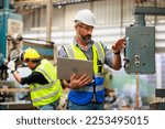 Portrait Caucasian professional Engineer factory. Engineering working with team and digital tablet computer in safety hardhat at factory industrial facilities. Heavy Industry Manufacturing Factory