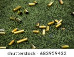 bullet shells ground. Cases of bullets lying on the floor of artificial grass