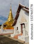 Small photo of Mondop is an open structure with a cruciform, multi tiered roof with large red gable, is next to Phra Borommathat Chae Haeng, Nan, Thailand.
