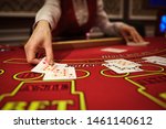 Small photo of The croupier in the casino does a shuffle of cards