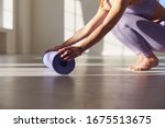 Fitness yoga exercise workout woman. A woman with a yoga mat in a white room in a bright room.