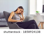 Small photo of Burned out employee with laptop computer sick and tired of making changes in her project and disappointed with her work. Young Asian woman trying to get work done in spite of bad wi-fi connection