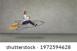 Small photo of Side view of excited smiling laughing woman flying in air riding hand drawn cartoon doodle rocket with burning blast off flame. Using creative power, reaching success, achieving business goal concept