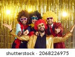 Small photo of Happy friends point fingers at camera inviting you to join 70s style fancy dress fun groovy disco party. Funny photobooth group portrait of excited young people at New Year Eve or birthday celebration