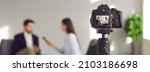 Small photo of Blurry copy space banner background with a closeup shot of a modern video camera with a digital display recording an interview in a TV show studio. Mass media, television, and technology concepts