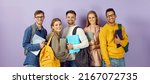 Small photo of Diverse group of smiling university or college students. Happy multi ethnic young friends in casual wear with backpacks, class textbooks and modern laptop PCs standing together and looking at camera