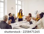 Small photo of Woman receives ovation she deserves at work meeting for successful presentation on increasing sales from multiethnic team of happy positive coworkers sitting at table in modern white office boardroom