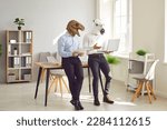 Small photo of Animal people using laptop in office workplace. Team of 2 business men in unusual funny masquerade fantasy Halloween dinosaur horse masks working together, holding notebook device and leaning on desk