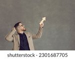 Small photo of Side profile view happy male employee businessman in suit holding ascending graph chart arrow going up and ahead isolated on grey background. Business success, job skills boost, career growth metaphor