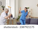 Small photo of Senior patient showing aggression toward medical worker. Old man wakes up in bad mood, starts fight with hospital staff, threatens nurse with crutch and gets very angry, dangerous and uncontrollable